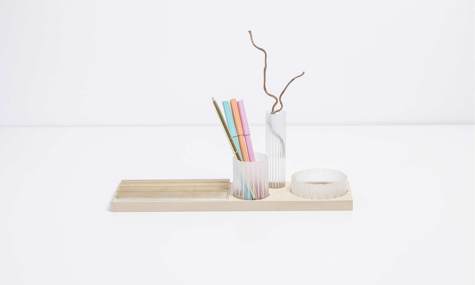 A modular stand for stationery inspired by industrial aesthetics. It is made of solid wood in combination with prefabricated parts from technical glass Simax. Designed by Jiri Krejcirik.